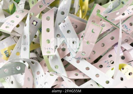 The discarded paper edges from fanfold continuous stationery, recycle or reuse for shockproof material Stock Photo