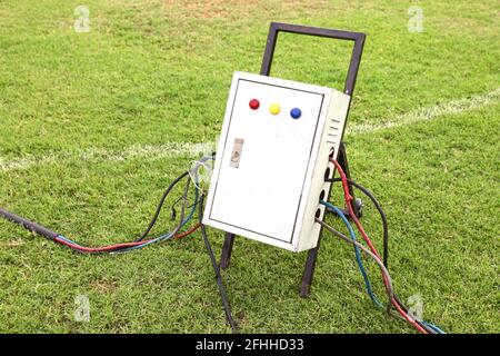 Old and dirty outdoor electrical power distribution box with circuit breaker and signal lights, industrial high voltage electricity safety equipment Stock Photo