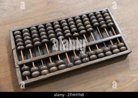 Closeup rusty old and dirty wood abacus on wooden table Stock Photo