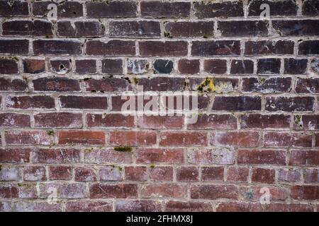 Distressed, Weathered brick wall made from reclaimed bricks. Red brick wall Stock Photo