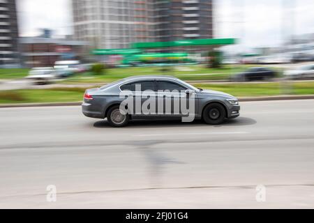 Ukraine, Kyiv - 20 April 2021: Silver Volkswagen Passat car moving on the street. Editorial Stock Photo