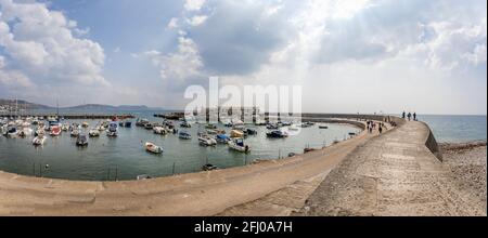 Panoramic view of The Cobb and harbour in Lyme Regis, Dorset, UK on 21 April 2021 Stock Photo