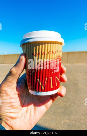 A take away disposable compostable small cup of Vinci espresso coffee held in a hand Stock Photo