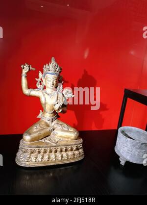 Delhi, India - September 30, 2017: Posing statue of White Tara Buddha Statue. face and hand symbol of love and purity. Buddhist culture and art agains Stock Photo