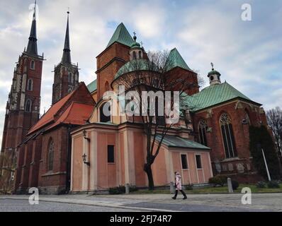 WROCLAW, POLAND - December 29, 2017: Wide angle shot of people walking against famous landmark Cathedral of St. John the Baptist church.