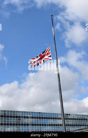 Flag flying at half-mast at Milton Keynes train station. Stock Photo