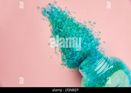 Blue sea salt on pink background, nobody Stock Photo