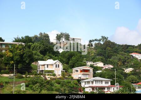 Parliament Building among hillside residences of St Georges Port Town on the Caribbean Island of Grenada. Stock Photo