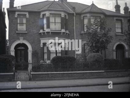 1940s, historical, exterior view of two semi-detached Victorin houses at Seven Kings, Ilford, Essex, England, UK. These large two-storey properties were built around 1850 and had ornate, decorative stone work around the windows and entrance that set them apart from other victorian semi's. Stock Photo