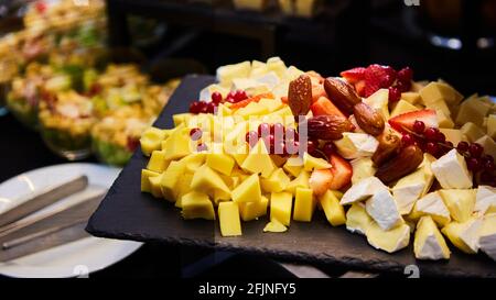 Cheese plate with cheeses Dorblu, Parmesan, Brie, Camembert and Roquefort. Shallow dof Stock Photo