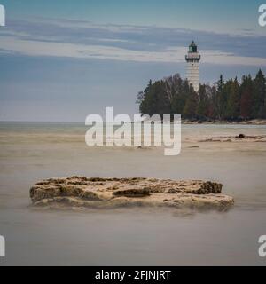 Cana Island lighthouse near Baileys Harbor in Door County Wisconsin. This Lake Michigan lighthouse has undergone extensive restoration over several. Stock Photo