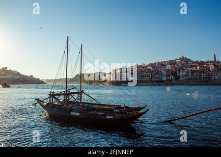 Wine barges on the Douro River in the historical city of Porto at sunset - Portugal. Stock Photo