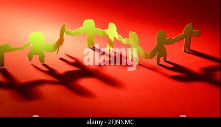 Paper chain team holding hands. Teamwork. Partnership Stock Photo