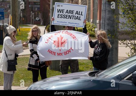 Vaughan, Canada - Apr 25, 2021: people holding banners we are all essential and  love my country hate my government   protesting  COVID-19 shutdown me Stock Photo