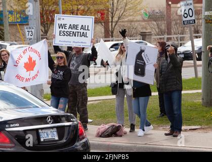 Vaughan, Canada - Apr 25, 2021: people holding banners we are all essential and  love my country hate my government   protesting  COVID-19 lockdownmea Stock Photo