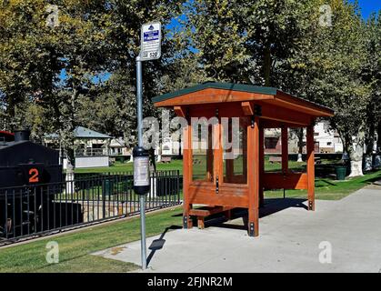 Tuolumne County transit bus stop, #520, route 5,  shelter at the Tuolumne West Side Memorial Park, California Stock Photo