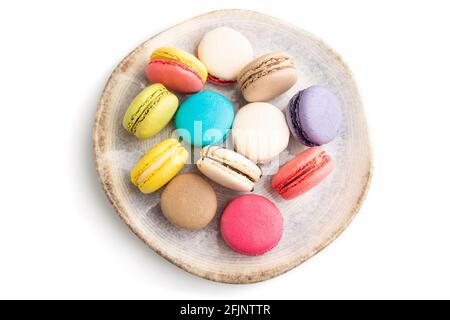 Multicolored macaroons on ceramic plate isolated on white background. top view, still life, flat lay, close up. Breakfast, morning, concept. Stock Photo