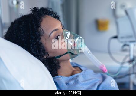 Ventilator monitor and african american female patient in hospital