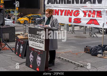 NEW YORK, NY – APRIL 25:   Taleen Babayan reads statements from local politicians as Armenians gathered in Times Square to commemorate the 106th anniversary of the 1915 Armenian Genocide on April 25, 2021 in New York City.  The normally large commemoration event was considerably scaled down and without guest speakers due to Covid-19 restrictions. Credit: Ron Adar/Alamy Live News Stock Photo