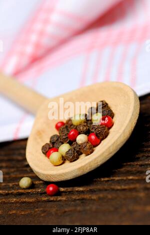 Peppercorns on wooden spoon, black, green, white and pink pepper () , peppercorns Stock Photo