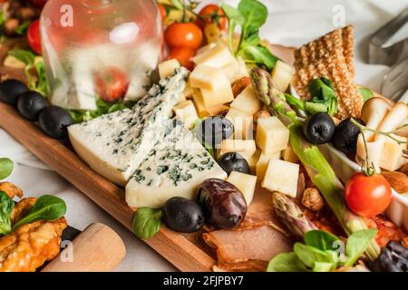 Close up on appetizer food on the table black olives and cheese Stock Photo