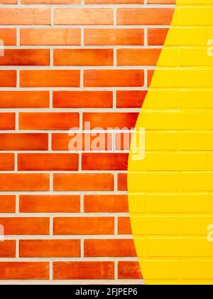 Brick wall background with yellow painted. Empty space on vivid color brick wall texture, vertical style. Stock Photo
