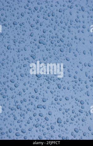 Blue abstract sky and raindrops on glass window Stock Photo