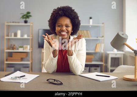 Happily smiling satisfied african american woman at table in office portrait Stock Photo