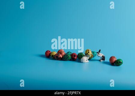 bunnies and colorful Easter eggs on a blue background Stock Photo
