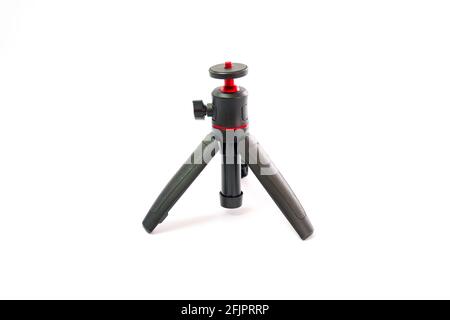 Small black tripod with red ball head for smartphone camera isolated on white background Stock Photo