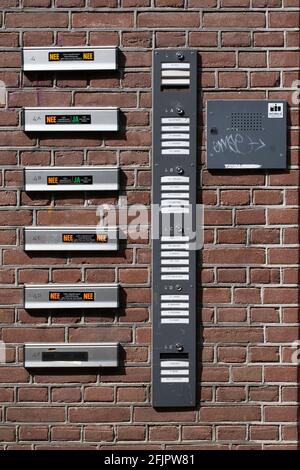 Vertical row of mailboxes, doorbells and intercom for residents in an apartment building Stock Photo