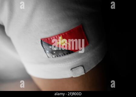 Patch of the national flag of the Papua New Guinea on a white t-shirt Stock Photo