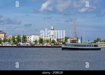 Rostock, Mecklenburg-Western Pomerania, Germany - June 14, 2020: View from Hohe Duene towards Warnemuende with the lighthouse and a harbour cruise shi Stock Photo