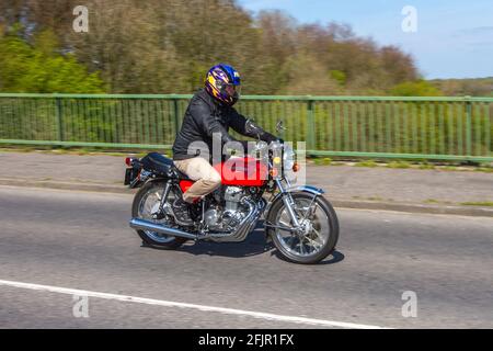 Honda cb 400 four super sport 1970's; 1977 70s red Four 400 408cc motorbike rider; two wheeled transport, motorcycles, vehicle on British roads, motorbikes, motorcycle bike riders motoring in Manchester, UK Stock Photo