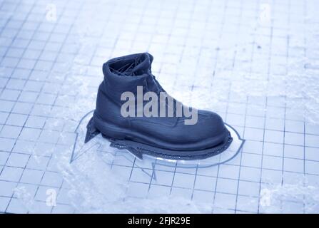 3D printer prints the form of molten plastic green. Stock Photo