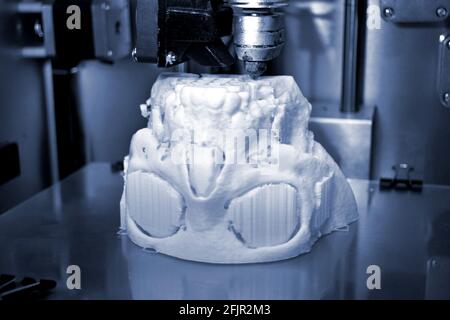 3D printer prints the form of molten plastic white. Stock Photo