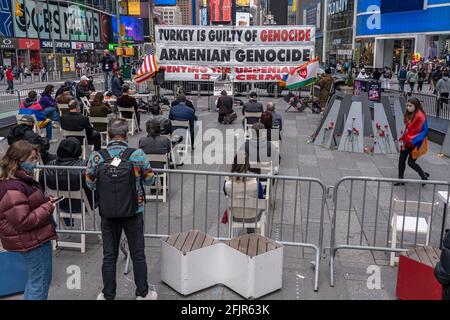 Armenians attend a ceremony in Times Square to commemorate the 106th anniversary of the 1915 Armenian Genocide on April 25, 2021 in New York City.The normally large commemoration event was considerably scaled down and without guest speakers due to Covid-19 restrictions. The day was marked with Armenian flags and calls for accountability. President Joe Biden's recognition of the Armenian genocide was met Saturday by tempered satisfaction from the nation's US Diaspora, with some saying the words need to result in more pressure against Turkey. Stock Photo