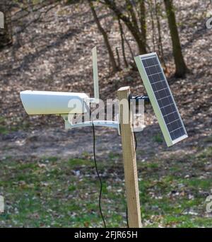 Surveillance camera with solar panel. Solar powered CCTV camera in remote rural location. Stock Photo