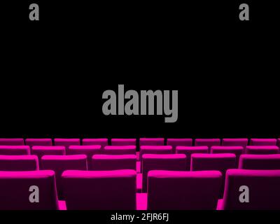 Cinema movie theatre with pink seats rows and a black copy space background Stock Photo