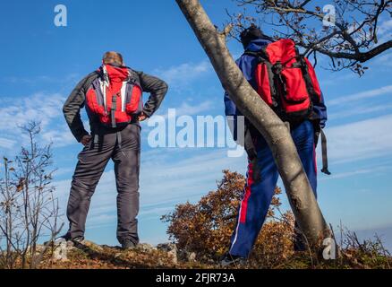 Two Hikers enjoying a view from the top of a mountain. Stock Photo