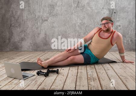 Funny yoga. Fat man doing yoga exercises in the room Stock Photo - Alamy