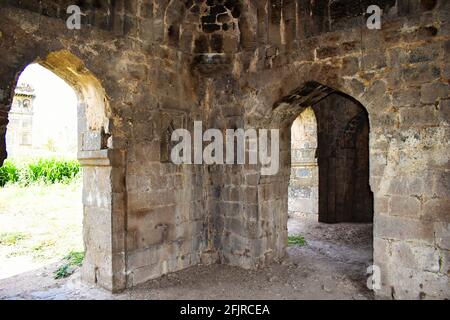 Corridor arches built with basalt stone entrance Gate of Bagh Rauza,  Bagh Rauza is a small complex that holds the tomb of Ahmed Nizam Shah and other Stock Photo