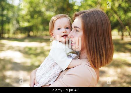 happy harmonious family outdoors. mother with her baby, playing in the summer on the nature Stock Photo