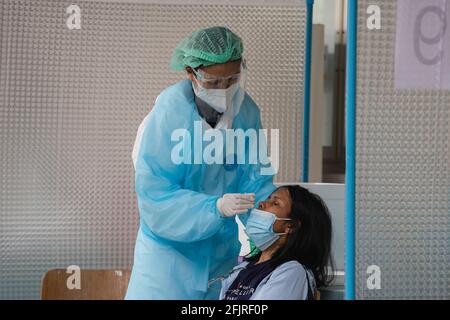 Bangkok, Thailand. 26th Apr, 2021. A medical staff f wearing a personal protective equipment suite (PPE) collects nasal swab sample from a woman at COVID-19 testing center. COVID-19 testing center at Thai-Japanese Bangkok Youth Center. Credit: SOPA Images Limited/Alamy Live News Stock Photo