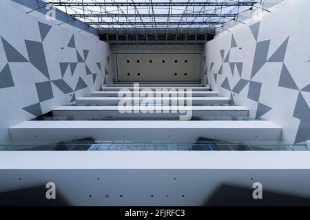Interior view of a modern office building with gray and white tile wall Stock Photo