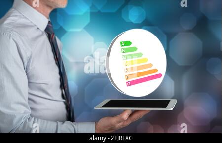 Energy efficiency concept above a tablet held by a man Stock Photo