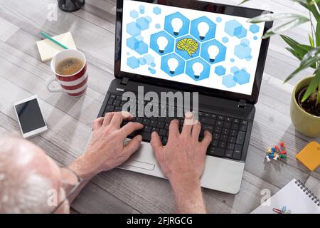 Human brain ideas concept shown on a laptop used by a man Stock Photo