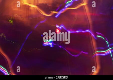 Long exposure photo of colorful moving lights creating beautiful abstract patterns. Stock Photo