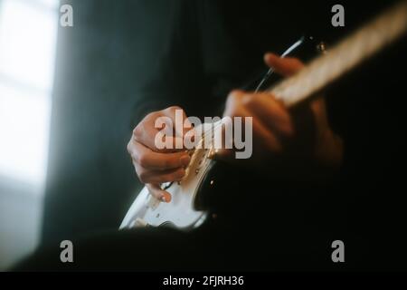 man playing an electric guitar on stage Stock Photo
