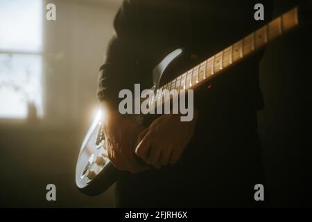 man playing an electric guitar on stage Stock Photo